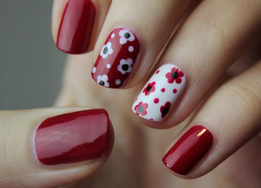 nail art with beautiful flowers, and red nail polish.|Nailcarewithsam